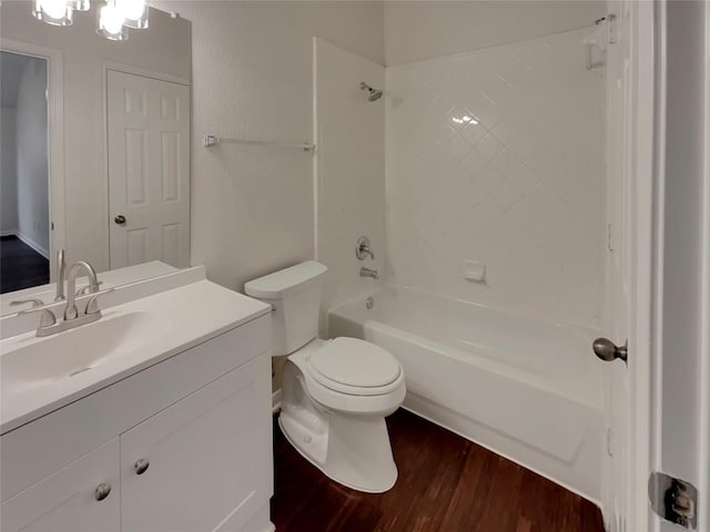 full bathroom featuring hardwood / wood-style flooring, vanity, toilet, and tiled shower / bath combo