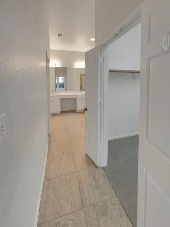 hall featuring light tile patterned flooring