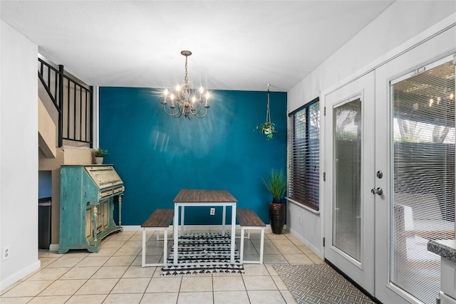 dining area with french doors, a notable chandelier, and light tile patterned floors