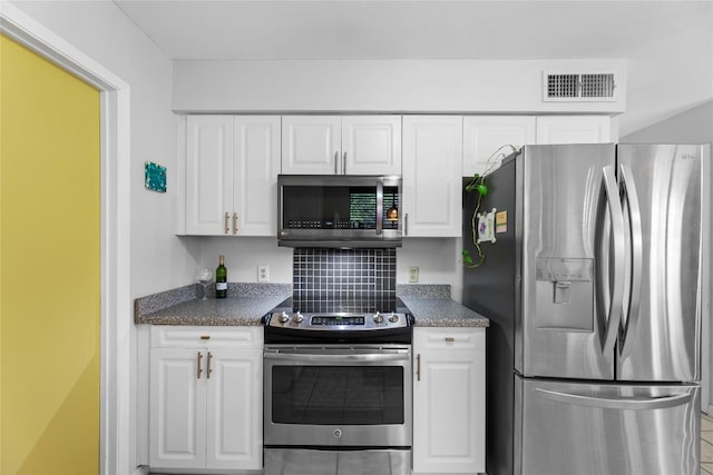 kitchen featuring appliances with stainless steel finishes, decorative backsplash, and white cabinets