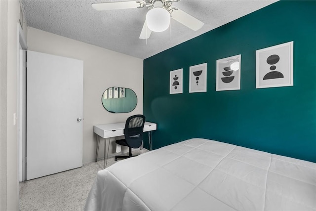 bedroom with ceiling fan and a textured ceiling