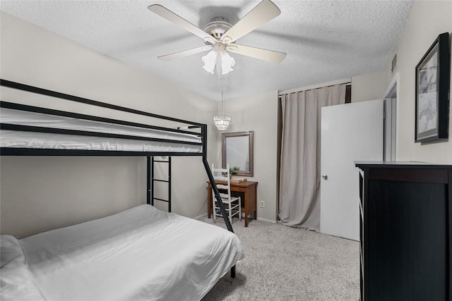 bedroom featuring ceiling fan, light carpet, and a textured ceiling