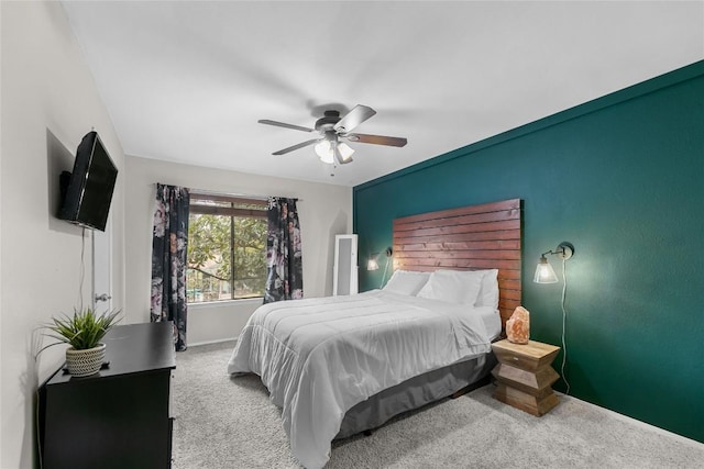 bedroom featuring ceiling fan and carpet