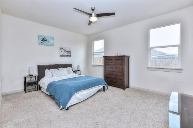 carpeted bedroom with baseboards and a ceiling fan