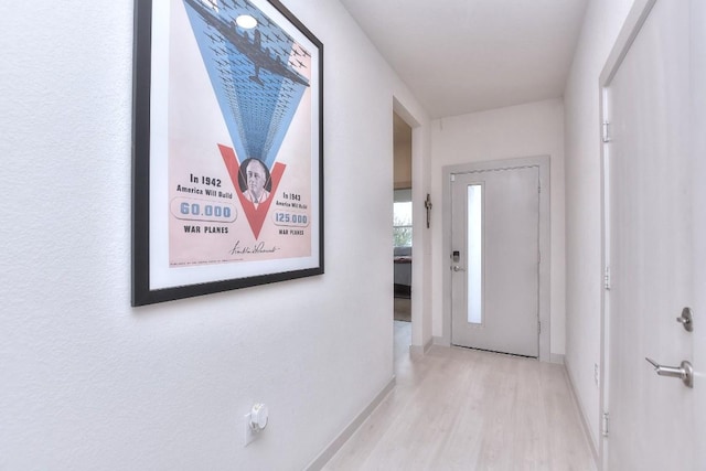 hallway with light hardwood / wood-style flooring