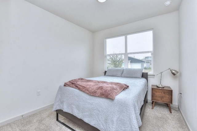 bedroom featuring light carpet