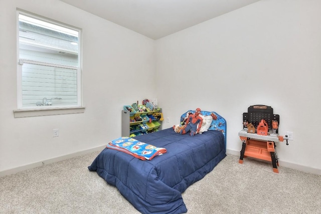 bedroom featuring baseboards and carpet