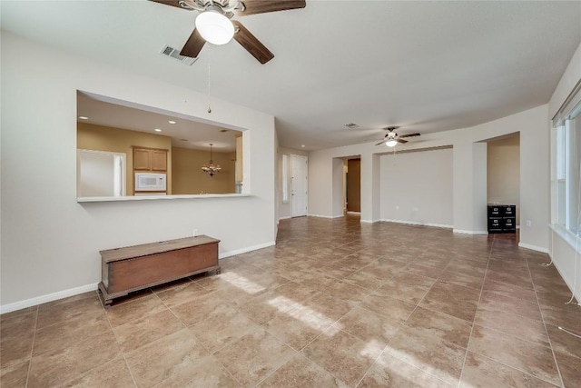 unfurnished living room with ceiling fan with notable chandelier