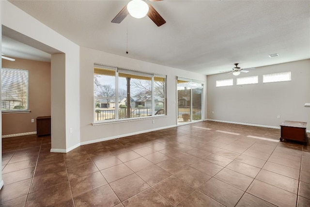 empty room featuring tile patterned flooring and ceiling fan