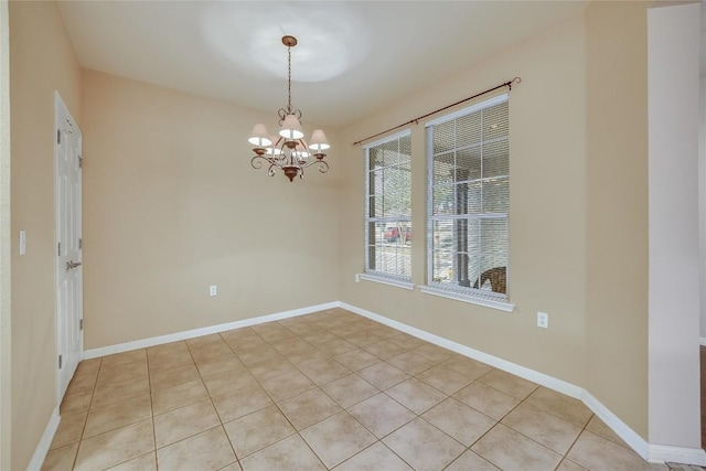 unfurnished room featuring light tile patterned flooring and an inviting chandelier