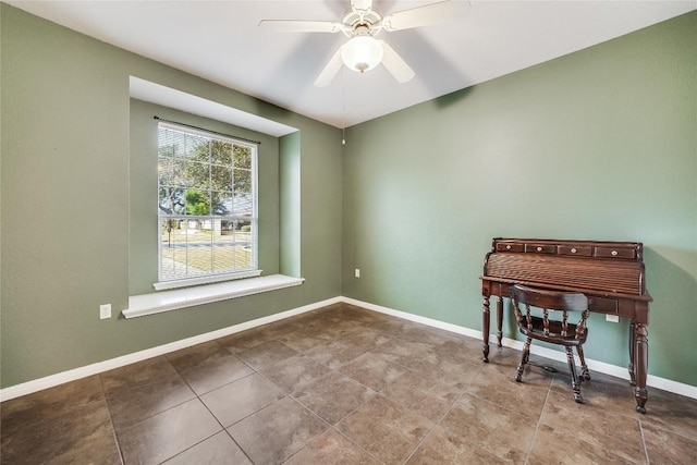 tiled spare room with ceiling fan