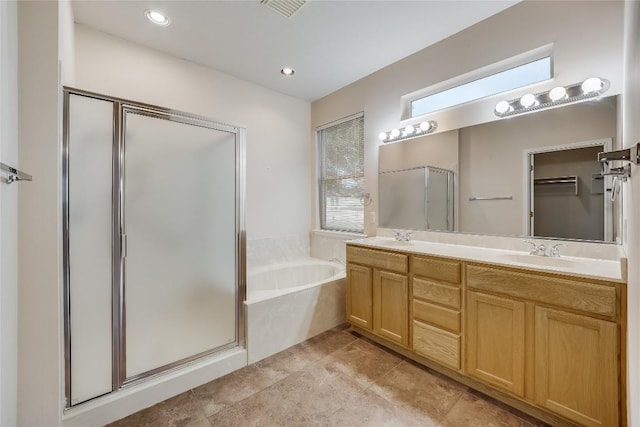 bathroom with vanity, tile patterned floors, and plus walk in shower