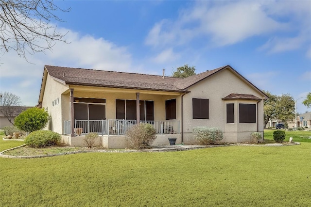 rear view of property with a yard