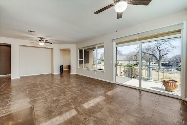 unfurnished living room featuring ceiling fan