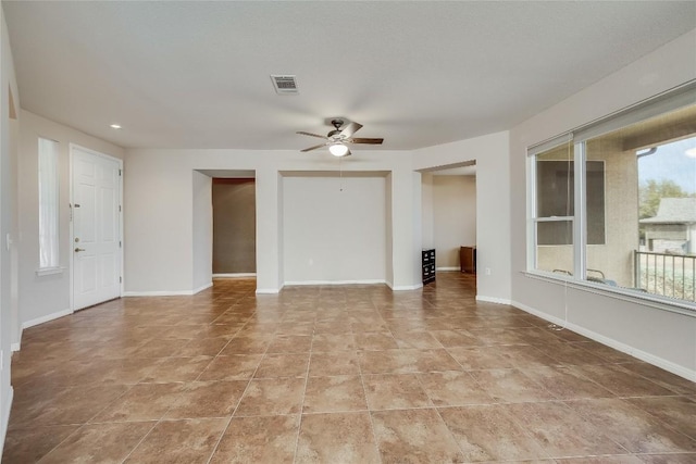 unfurnished living room with light tile patterned flooring and ceiling fan