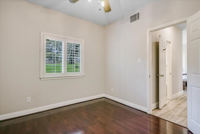 spare room featuring hardwood / wood-style flooring and ceiling fan