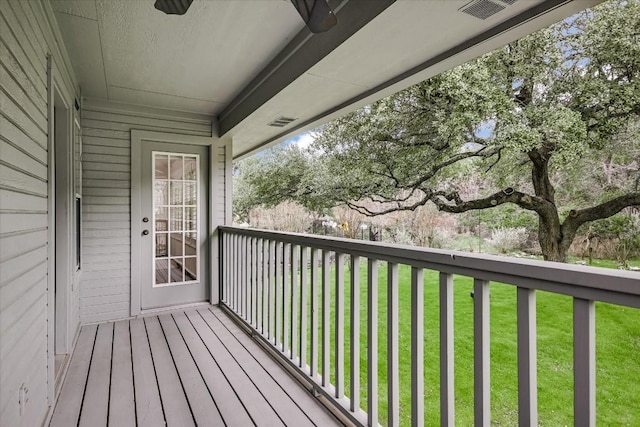 wooden deck featuring a yard