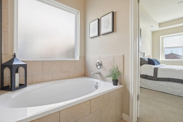 bathroom featuring tiled bath