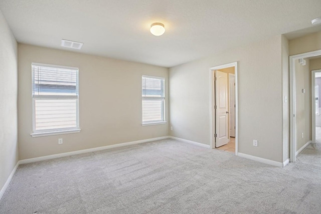 unfurnished bedroom featuring light carpet