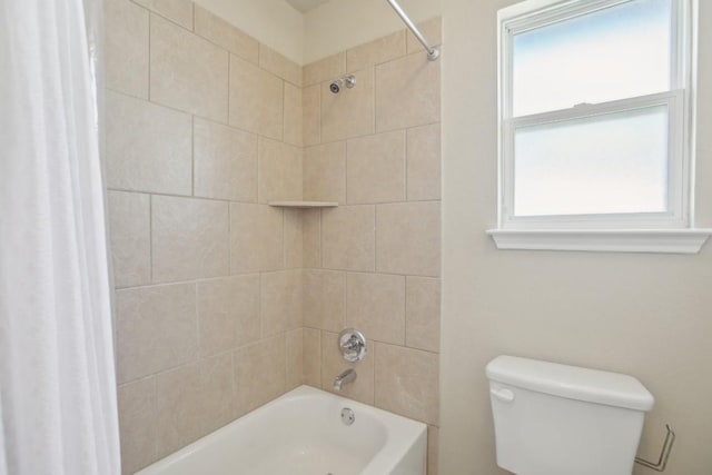 bathroom with shower / tub combo with curtain and toilet