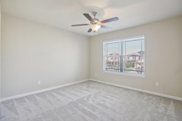 spare room featuring light carpet and ceiling fan