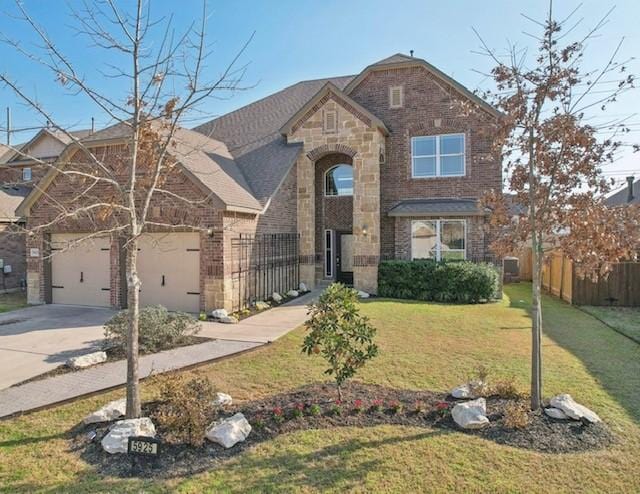 front of property featuring a garage and a front yard