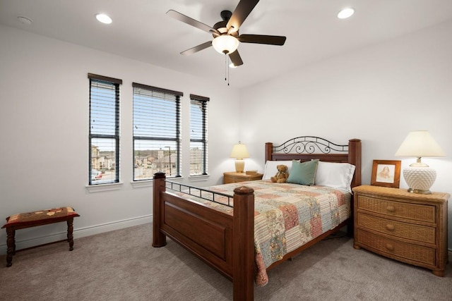 bedroom featuring light colored carpet and ceiling fan