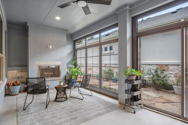 sunroom featuring ceiling fan