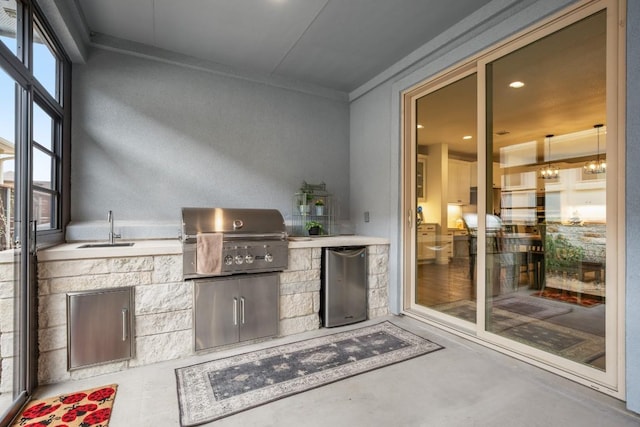 view of patio with exterior kitchen, sink, and grilling area