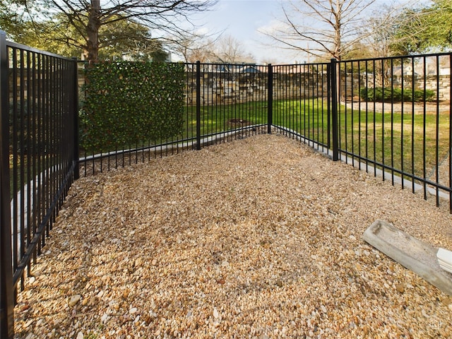 view of gate with a yard