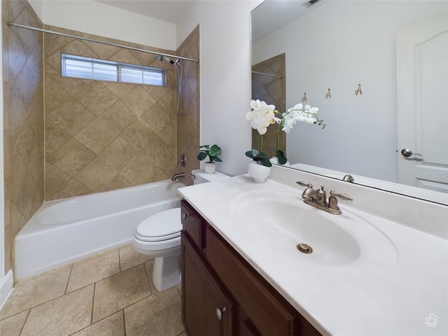 full bathroom with tiled shower / bath, vanity, and toilet