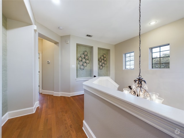 hallway with hardwood / wood-style flooring