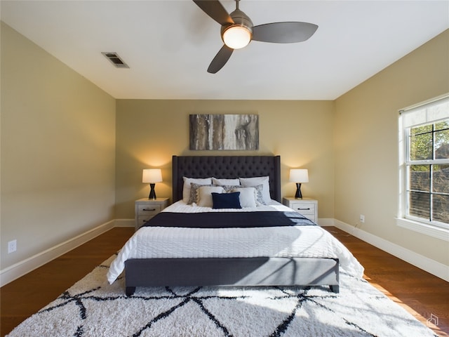 bedroom with ceiling fan and dark hardwood / wood-style flooring