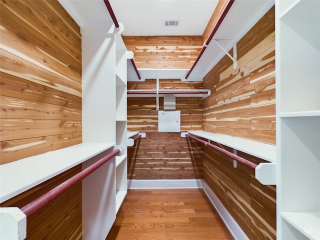 walk in closet with wood-type flooring