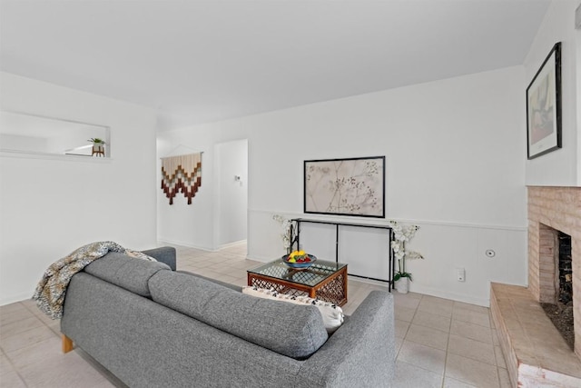 living room featuring light tile patterned floors and a fireplace