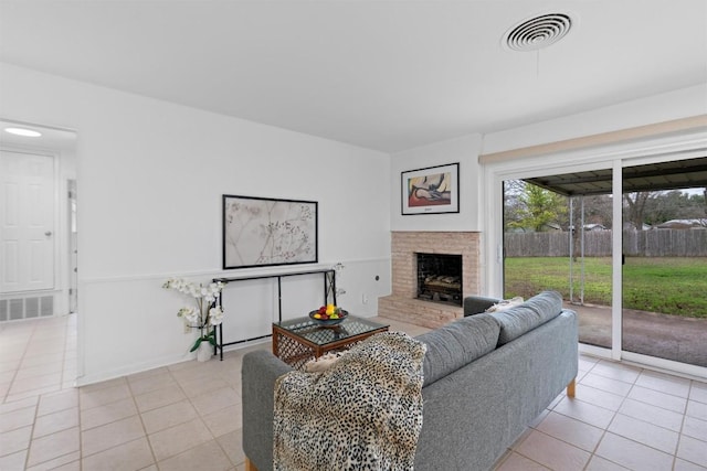 tiled living room featuring a fireplace