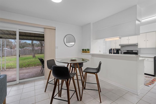 tiled dining area featuring sink