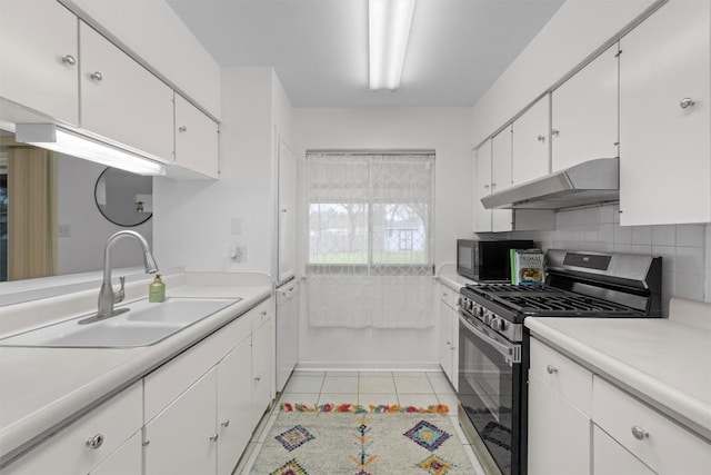 kitchen featuring white cabinetry, sink, gas stove, and light tile patterned floors