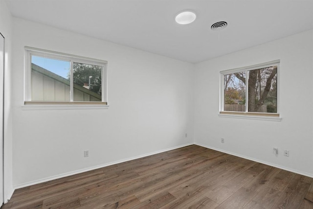 unfurnished room featuring dark hardwood / wood-style floors