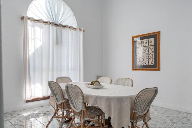 dining space with plenty of natural light and light tile patterned floors