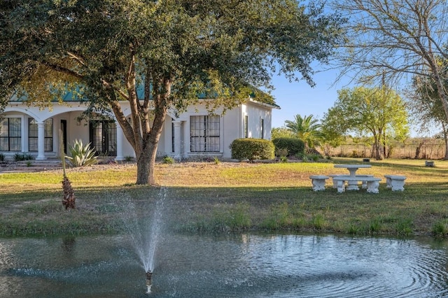 exterior space with a front yard and a water view