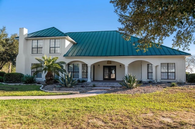 view of front of home featuring a front lawn and french doors