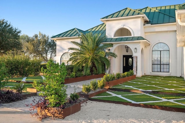 view of exterior entry with a lawn