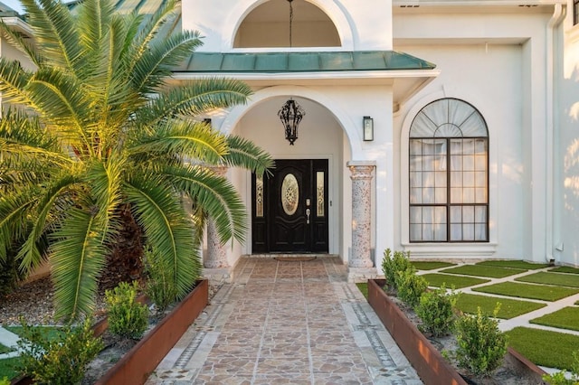 entrance to property with a lawn