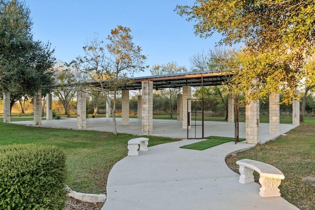 view of community with a patio and a lawn