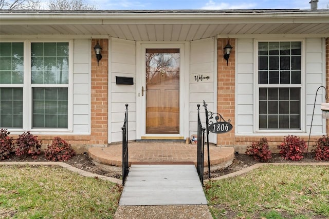 entrance to property with a yard