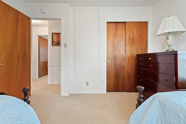 bedroom featuring a closet and light carpet