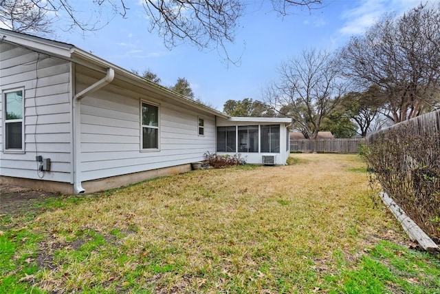 back of house with a sunroom and a yard