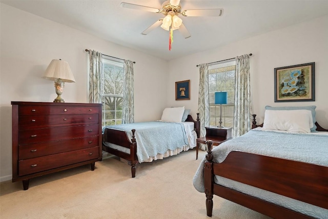 bedroom featuring light colored carpet and ceiling fan