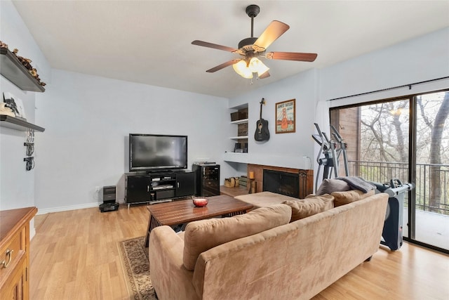 living room featuring ceiling fan and light hardwood / wood-style floors